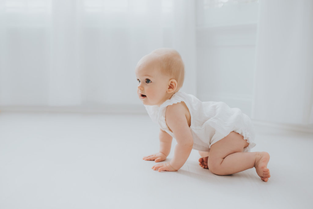 Baby crawling during photography session