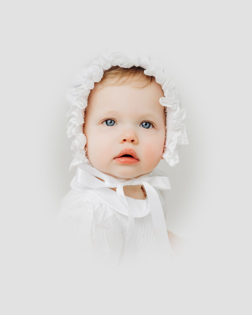 Heirloom Portraits Raleigh NC - color portrait of gorgeous 1 year old girl in bonnet.