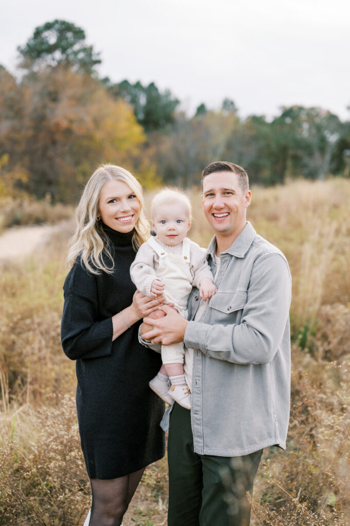 Family of three poses for beautiful Fall family portrait by Worth Capturing Photography